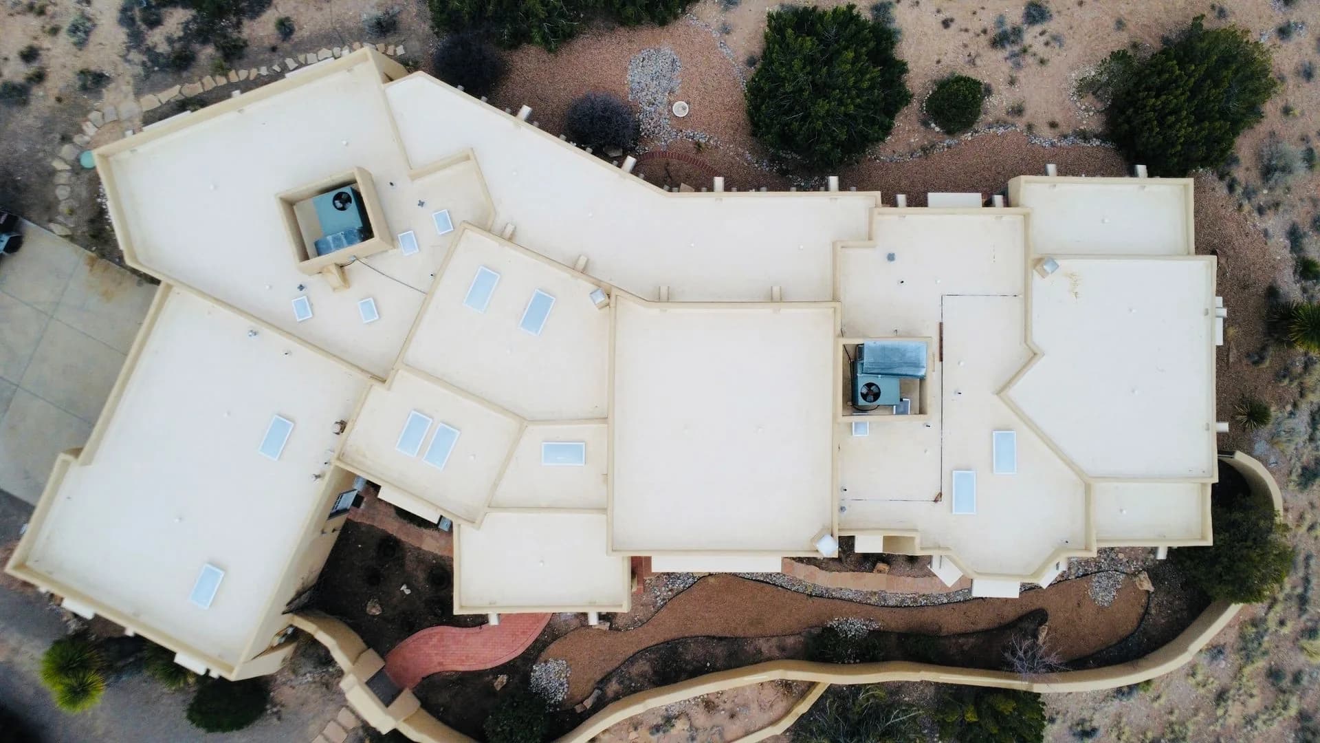 Flat roof maintenance on an adobe-style home in Northern New Mexico