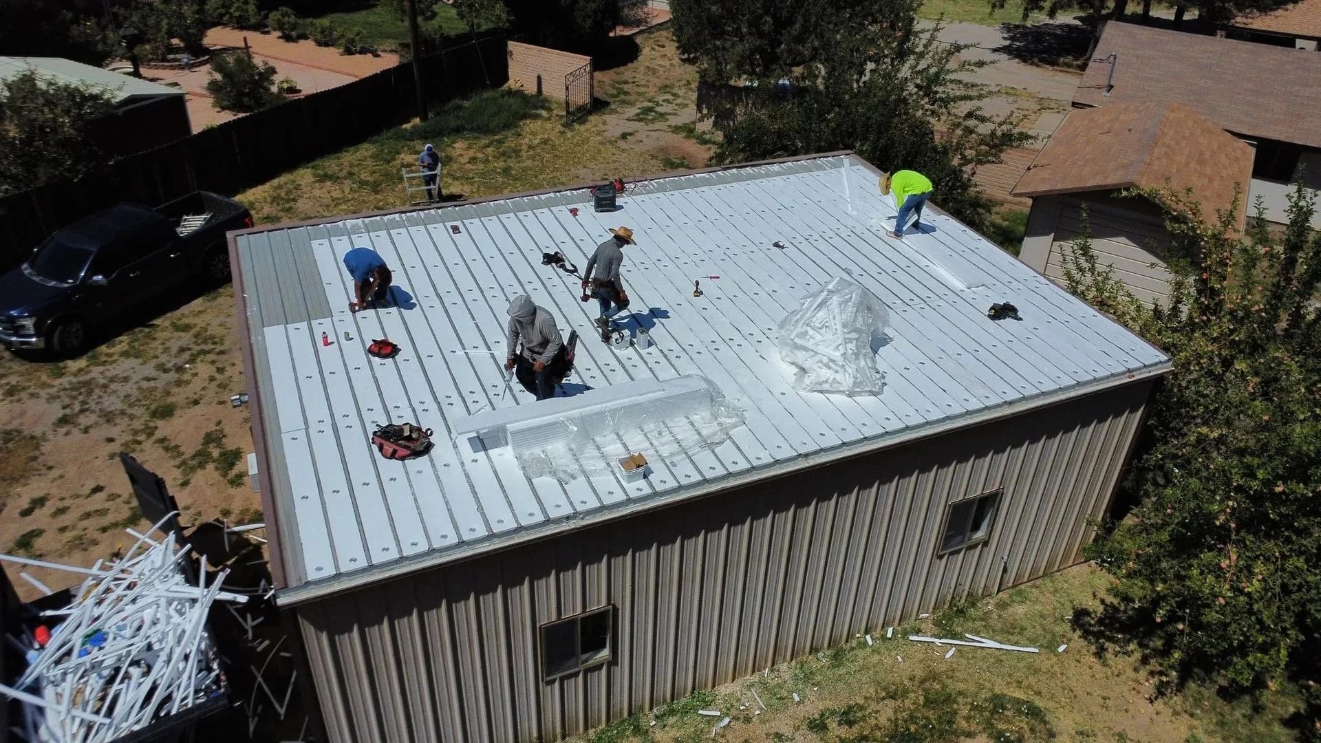 Standing-seam metal roof installation in progress, aerial view